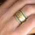 yellow gold sis, in white diamonds + emeralds,<br>with our popular diamond cross cigar band <span class='visuallyhidden'>Call or text 323-404-2959 if you need shopping assistance.</span>